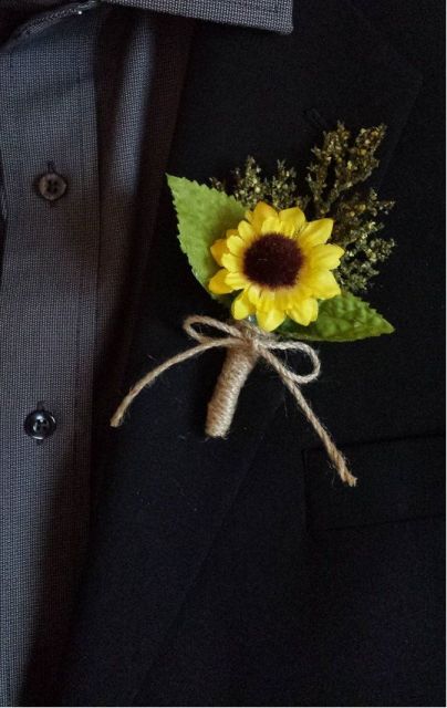 a rustic wedding boutonniere of a sunflower and greenery wrapped in twine is a very cool and pretty idea