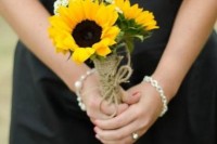 a bridesmaid bouquet of sunflowers, with wildflowers and a twine wrap is a lovely idea for a rustic wedding