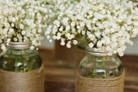 jars wrapped with twine and with baby’s breath are amazing for rustic wedding decor