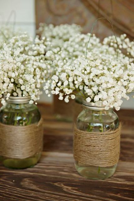jars wrapped with twine and with baby's breath are amazing for rustic wedding decor