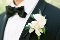 magnolia blooms make very cool boutonnieres for elegant groom’s looks, they contrast black tuxedos