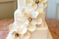a white square wedding cake decorated with white magnolias is a chic and elegant idea for a modern wedding with style