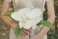 a single stem wedding bouquet of a large magnolia is a very elegant and unusual idea for a glam bride