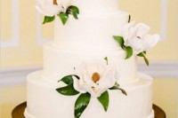 a white wedding cake decorated with white magnolias is a cool idea for a southern wedding