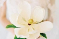 a large single magnolia bloom wedding bouquet is a cool idea for a bride who wants a special wedding bouquet of a single stem