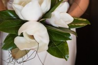a wedding bouquet of large magnolias is a cool idea to rock at a modern glam wedding, it’s an unusual idea