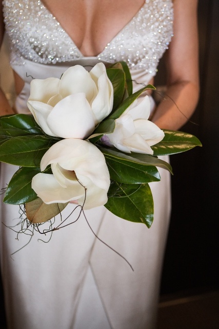 a wedding bouquet of large magnolias is a cool idea to rock at a modern glam wedding, it's an unusual idea