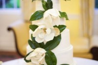 a white wedding cake decorated with white magnolias is a chic and statement idea, these blooms are great for decorating