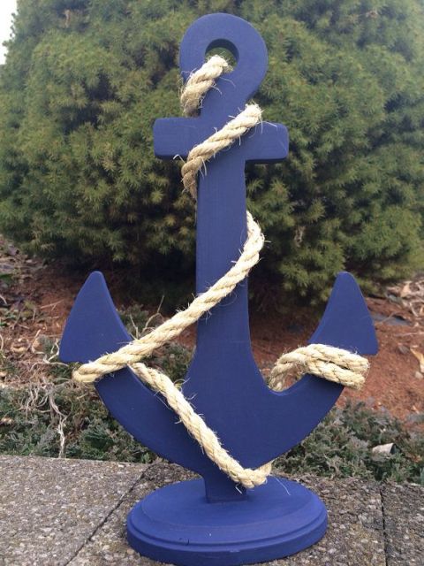 a navy anchor wrapped with rope is a stylish and cool decoration for a nautical wedding, or a seaside one, and you can DIY it