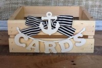 a wooden crate with a striped bow and an anchor, with a letter banner is a cool card box for a wedding