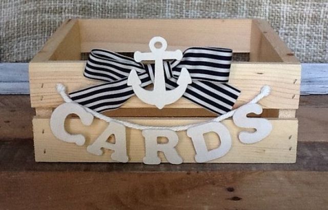 a wooden crate with a striped bow and an anchor, with a letter banner is a cool card box for a wedding