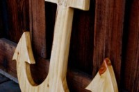 a light-stained wooden anchor as a wedding decoration for a nautical wedding or a wedding guest book