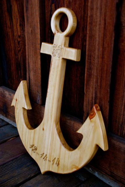 a light-stained wooden anchor as a wedding decoration for a nautical wedding or a wedding guest book