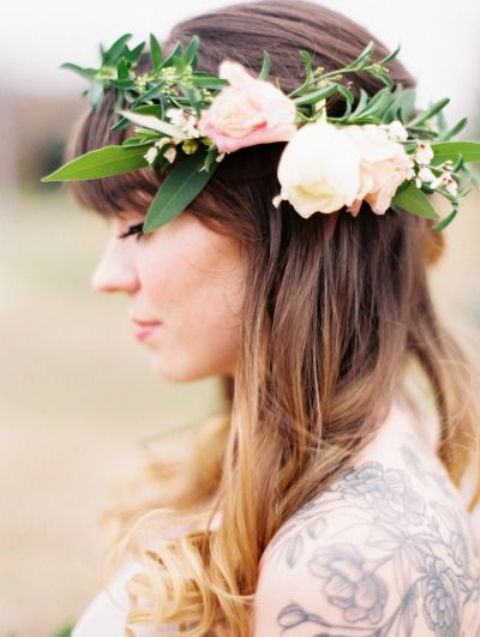 a textural flower crown with much greenery and white and blush oversized blooms on one side is a pretty boho wedding idea