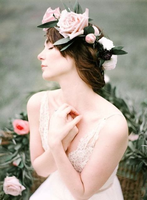a gorgeous pink and white floral crown with large roses and greenery is a lovely idea for a spring or summer bride