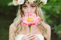 a lush and oversized spring flower crown with white and pink blooms and a bit of greenery for a textural look is amazing
