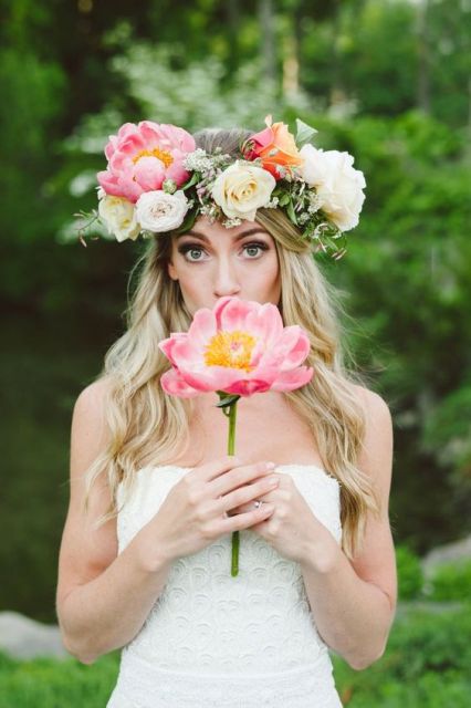 a lush and oversized spring flower crown with white and pink blooms and a bit of greenery for a textural look is amazing
