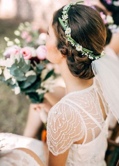a delicate small floral crown with greenery and white blooms is a subtle and chic idea for a spring bride