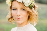 a lush floral crown of large white blooms, thistles and greenery is a lovely idea for a statement in your bridal look