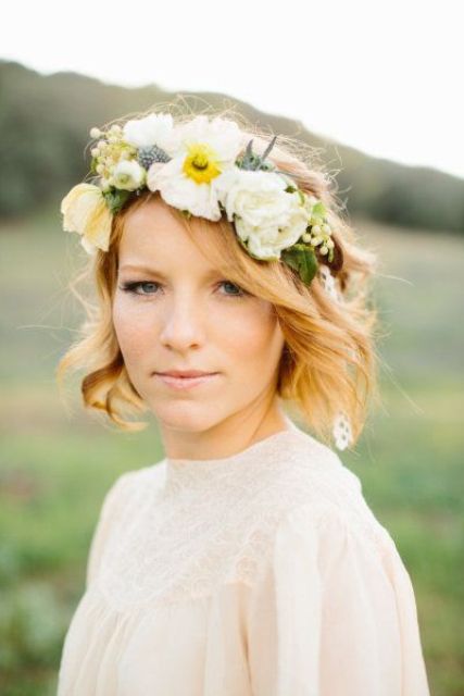 a lush floral crown of large white blooms, thistles and greenery is a lovely idea for a statement in your bridal look