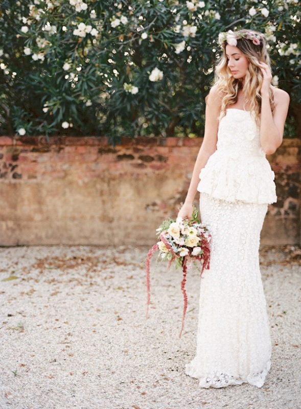a boho bridal look with a strapless top and a mermaid skirt, a delicate floral crown and a bouquet is a cool idea