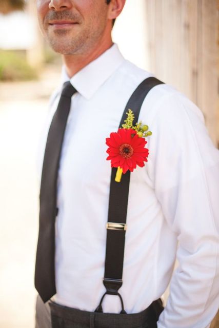 a bold red gerbera boutonniere with a bit of greenery is a lovely idea for a groom's look, it will catch an eye