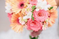 a bright wedding bouquet of pink roses, orange gerberas, greenery and some white blooms is a lovely idea for a bold spring or summer wedding