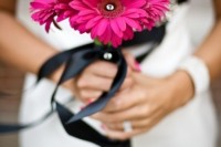 a pink gerbera wedding bouquet of black ribbon is a lovely and colorful accent for a bridal look