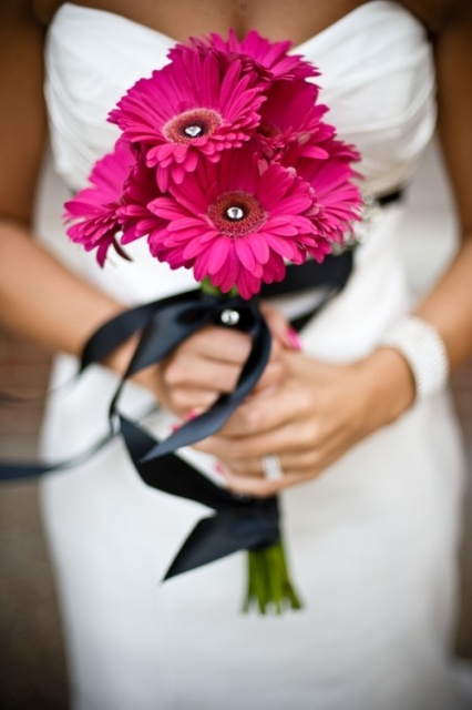 a pink gerbera wedding bouquet of black ribbon is a lovely and colorful accent for a bridal look