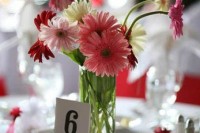 a cool wedding centerpiece of pink, coral, red and white gerberas is a lovely idea for a bold wedding