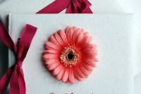 favors with bright orange gerberas and bold red bows are amazing for a chic and bold wedding