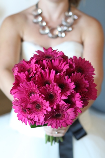 a super bold hot pink gerbera wedding bouquet is a bright and cool idea for a wedding, it won't break the bank