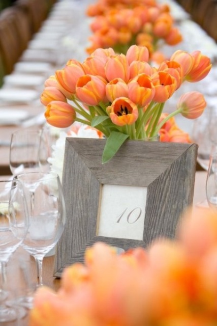 a super bold wedding centerpiece of orange tulips is a gorgeous touch of color, and even such an amount of flowers won't break the bank