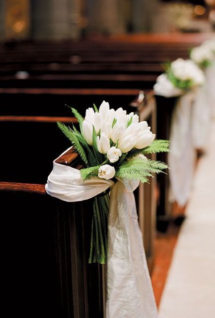 decorate your aisle chairs or benches with white blooms, greenery and a neutral wrap to make them look cooler and lovelier