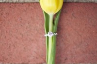 show off your wedding or engagement ring on a yellow tulip to add color to the wedding and to show the band in a delicate way