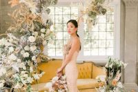 a beautiful pastel wedding backdrop of white and blush blooms, of greenery, dried fronds and leaves is a lush and chic idea