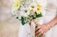 a beautiful wedding bouquet of white and yellow gerberas, baby’s breath and greenery plus neutral ribbon for a spring or summer wedding