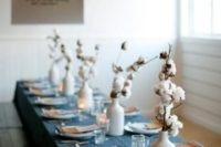 a blue chambray tablecloth and cotton centerpieces for a casual winter tablescape with no fuss