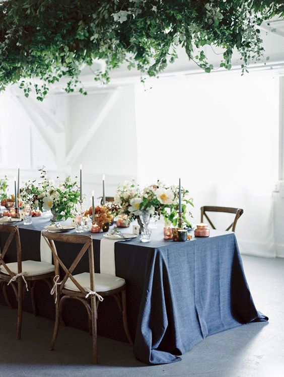 a blue chambray tablecloth gives color and texture to the tablescape and copper adds chic