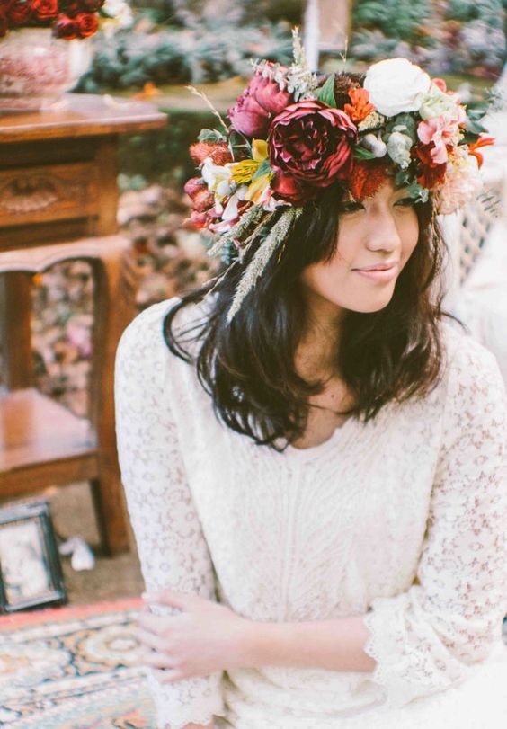 a bold and oversized floral crown with white, orange, fuchsia blooms, grasses and greenery for a spring or summer boho bride