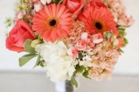 a bold wedding bouquet with coral gerberas and roses, blush and white hydrangeas and greenery for a bold summer wedding