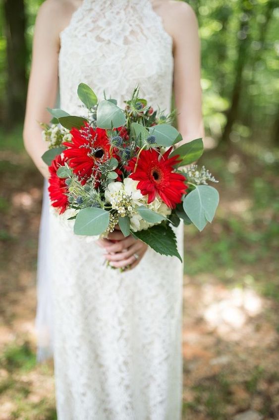 a bold wedding bouquet with red gerberas, white hydrangeas, thistles and greenery is amazing
