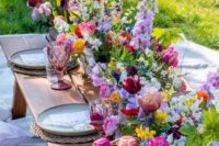 a bright spring wedding centerpiece of purple, pink, lilac, yellow blooms including daffodils and tulips is awesome