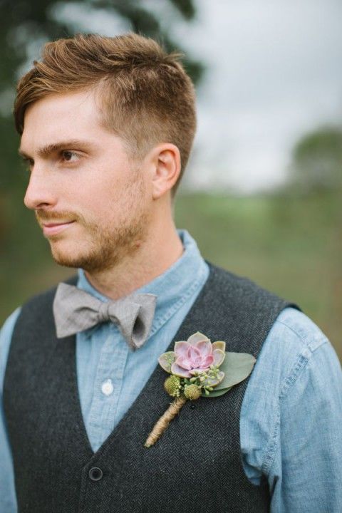 a chambray shirt, a woolen waistcoat and a printed bow tie plus a succulent boutonniere for a rustic groom's look