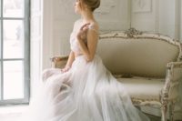 a chic bridal spearate with an embellished blush crop top and a white layered tulle skirt with a train