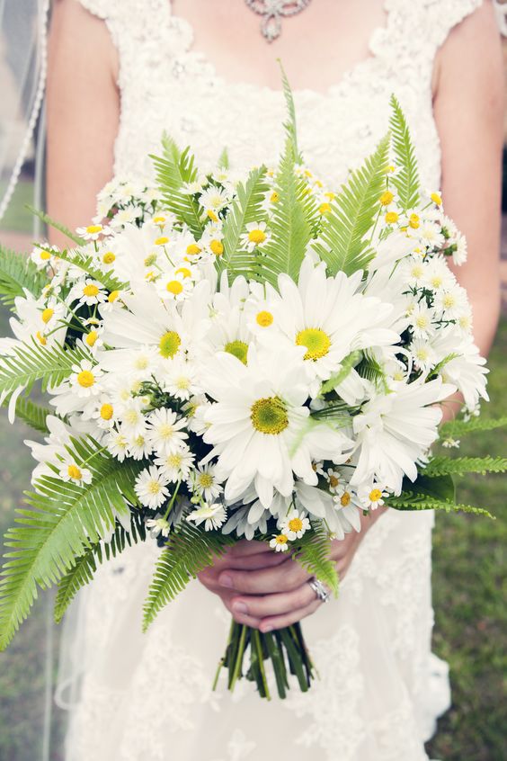 a cool and fun wedding bouquet of chamomiles, white gerberas and fern is a lovely idea for a woodland-inspired wedding