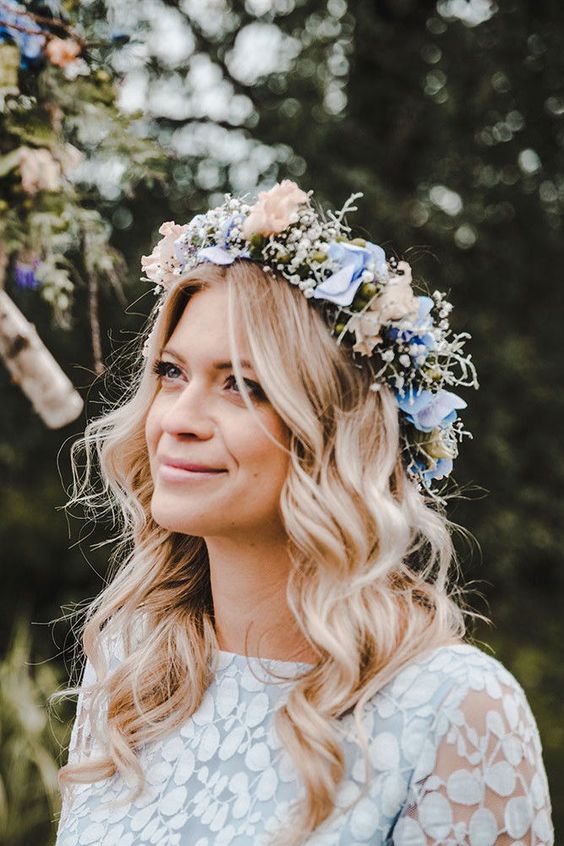a delicate pastel spring floral crown with blush and blue blooms and baby's breath is a gorgeous idea to rock