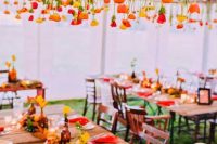 a grid with yellow, orange and red tulips is a creative and simple alternative to an overhead wedding installation