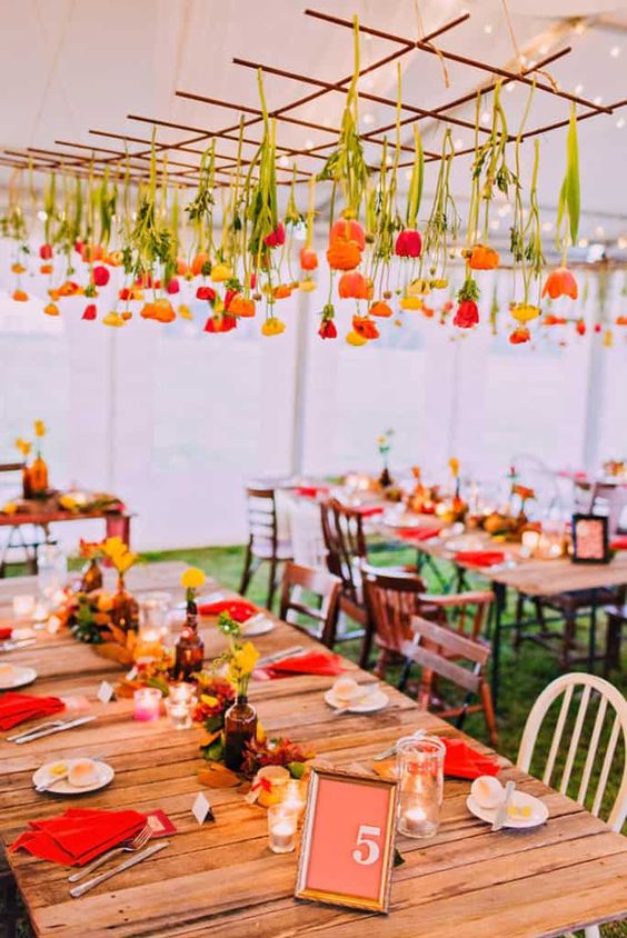 a grid with yellow, orange and red tulips is a creative and simple alternative to an overhead wedding installation