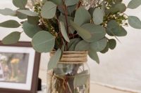 a jar wrapped with twine, with waxflower and eucalyptus is a very lovely idea for a rustic wedding and is easy to compose